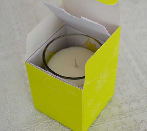 Yellow aroma soy votive candle in glass jar