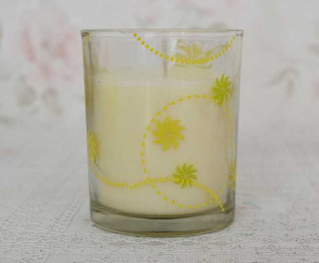 Yellow aroma soy votive candle in glass jar