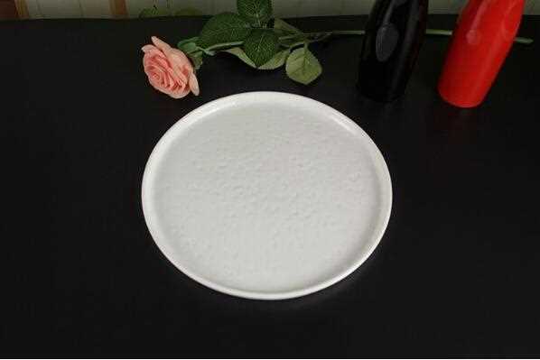 Beige ivory ceramic plate with bumping uneven surface