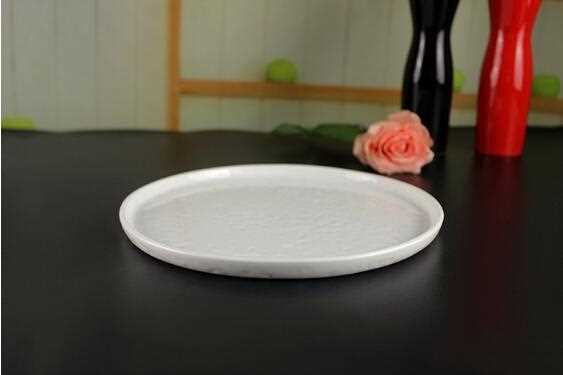 Beige ivory ceramic plate with bumping uneven surface