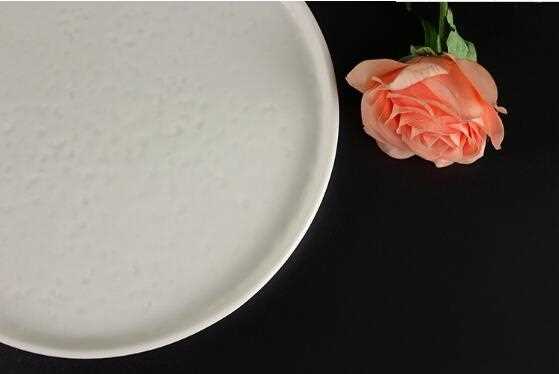 Beige ivory ceramic plate with bumping uneven surface